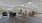 a room with large windows, tables with chairs and couches