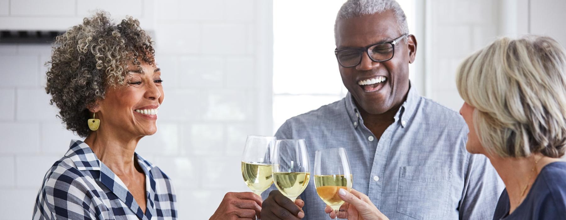 a few people toasting wine glasses