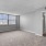 living room with large windows and carpet