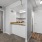 a room with a kitchen bar that looks into a living space