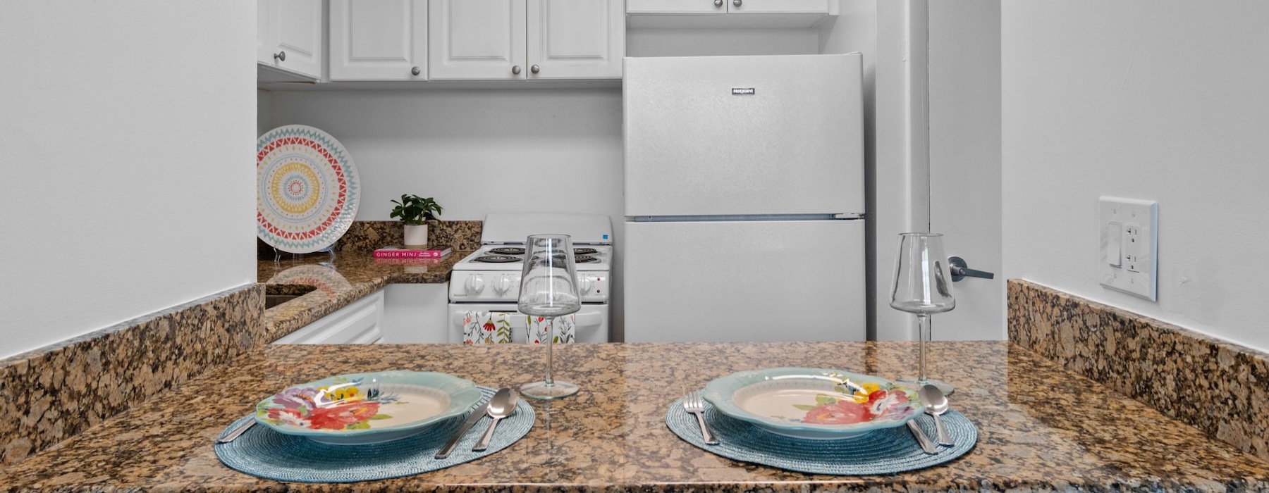 a kitchen with two placemats on a bar