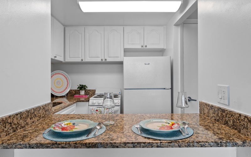 a kitchen with two placemats on a bar